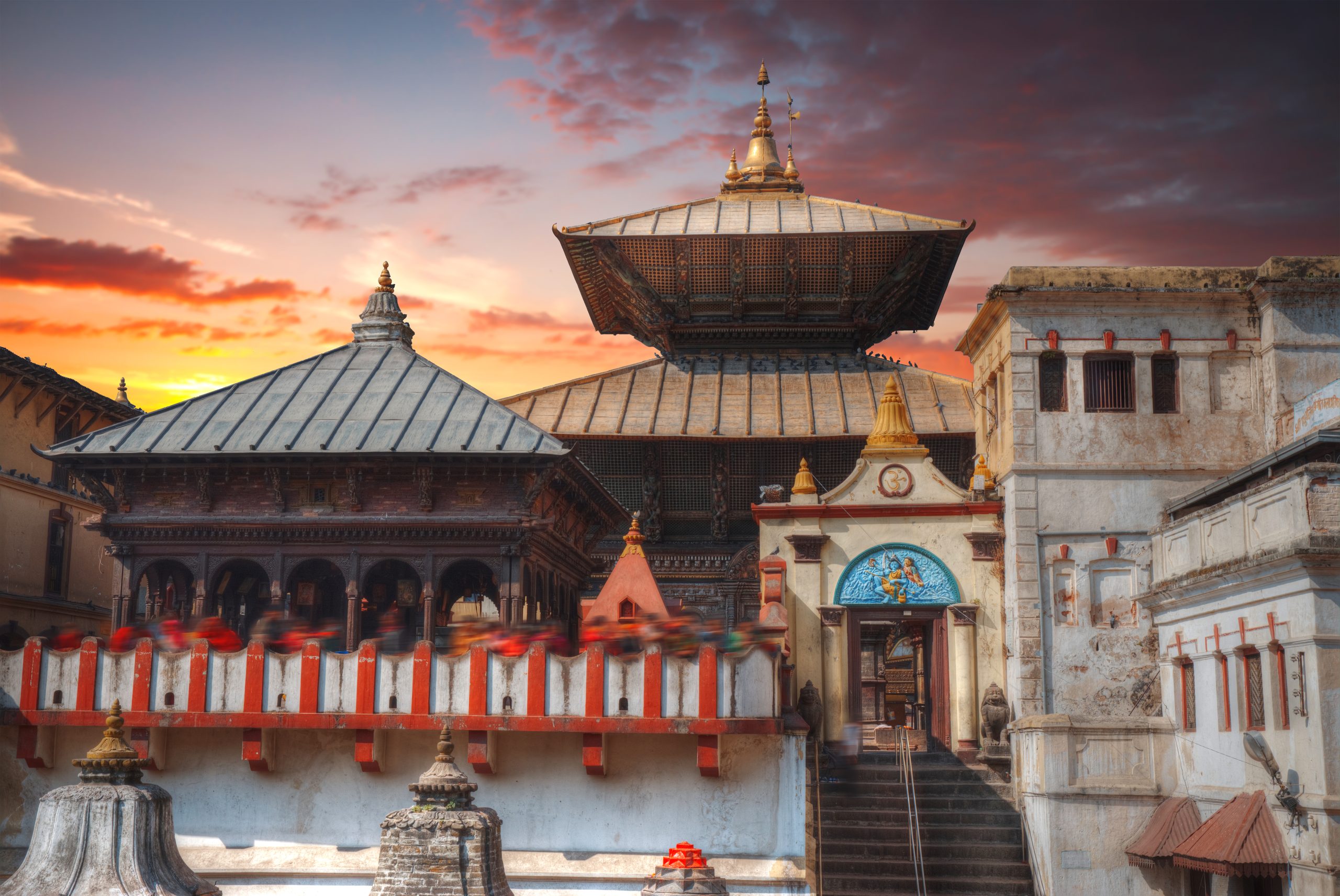 Freely walk monkey. Votive temples and shrines in a row at Pashupatinath Temple, Kathmandu, Nepal.