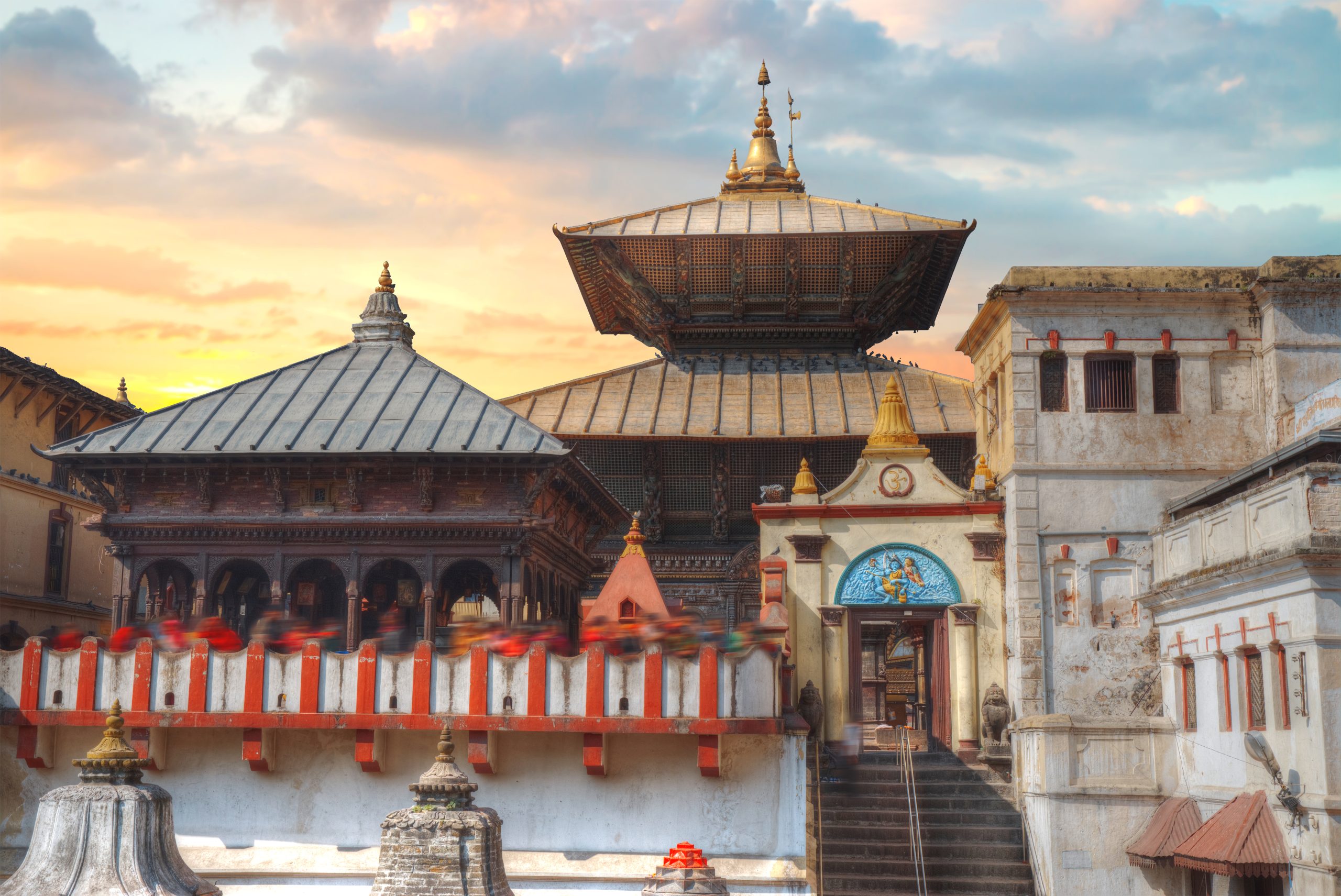 Freely walk monkey. Votive temples and shrines in a row at Pashupatinath Temple, Kathmandu, Nepal.